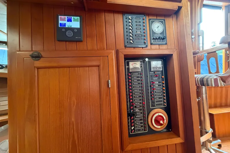 Slide: The Image of Electrical control panel on a 1988 Monk 36 boat, featuring gauges and switches. - 11