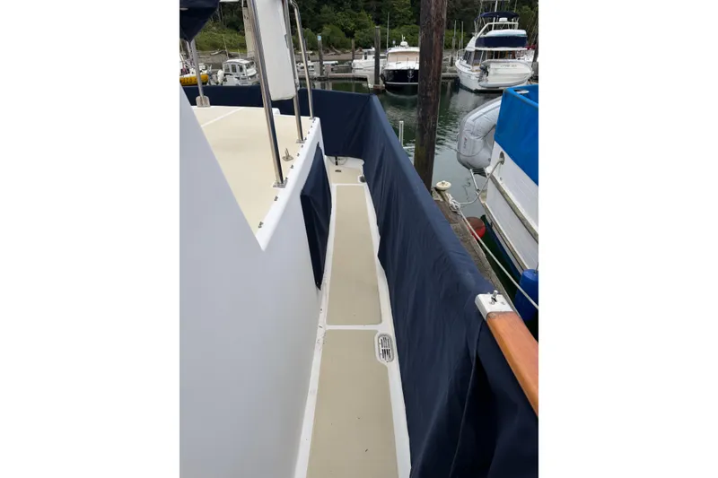 Slide: The Image of Side deck of a 1988 Monk 36 boat docked at a marina. - 22