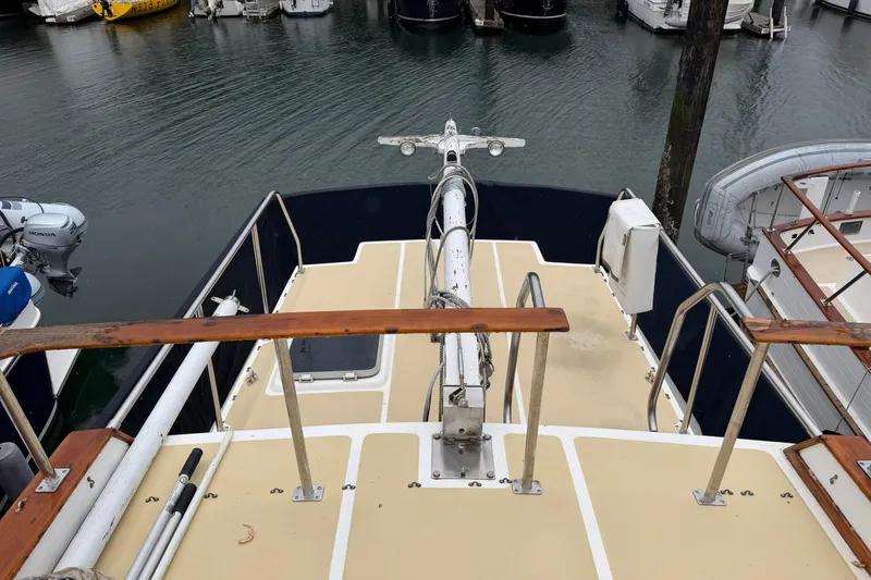 Slide: The Image of Aft deck of 1988 Monk 36 boat in marina, featuring railing and equipment. - 28