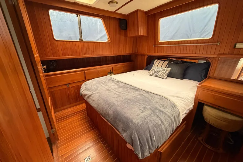Slide: The Image of Cozy wooden cabin interior of 1988 Monk 36 boat with bed and desk. - 17