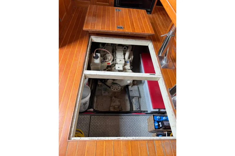 Slide: The Image of Engine compartment of a 1988 Monk 36 boat with wooden flooring. - 34
