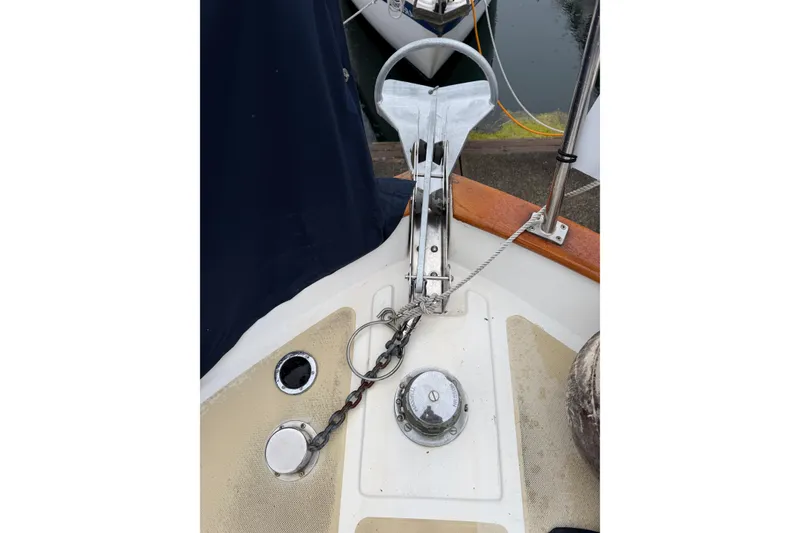 Slide: The Image of Anchor setup on 1988 Monk 36 boat, featuring chain and deck fittings. - 25