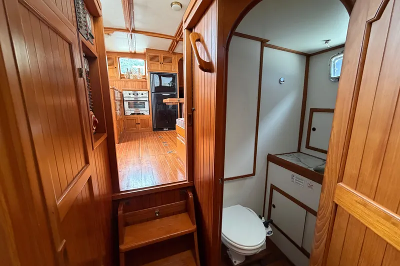 Slide: The Image of Interior of 1988 Monk 36 boat with wooden cabinetry and compact bathroom. - 14
