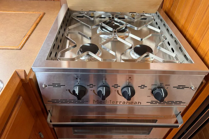 Slide: The Image of Stainless steel Mediterranean stove with four burners, in a 1988 Monk 36 boat kitchen. - 10