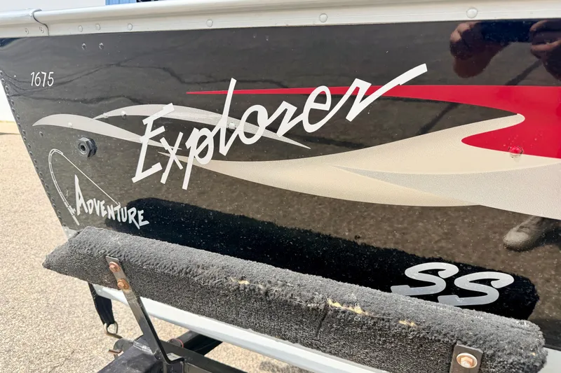 Slide: The Image of 2003 Lund 1675 Adventure SS boat with "Explorer" decal on black hull. - 10