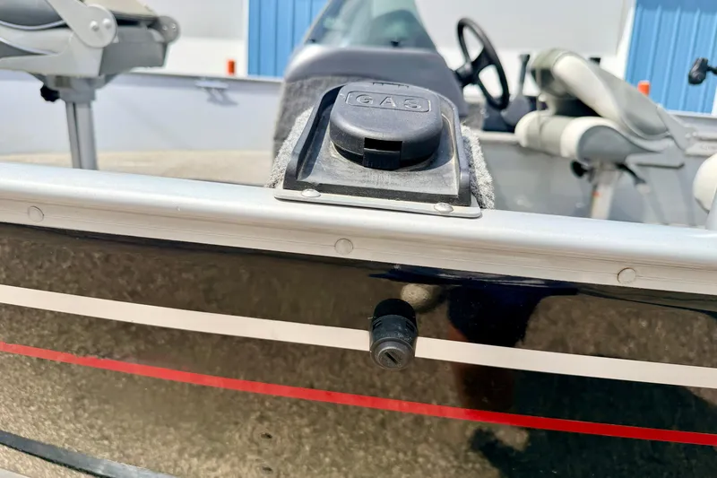 Slide: The Image of 2003 Lund 1675 Adventure SS boat showing gas cap and interior seating. - 12