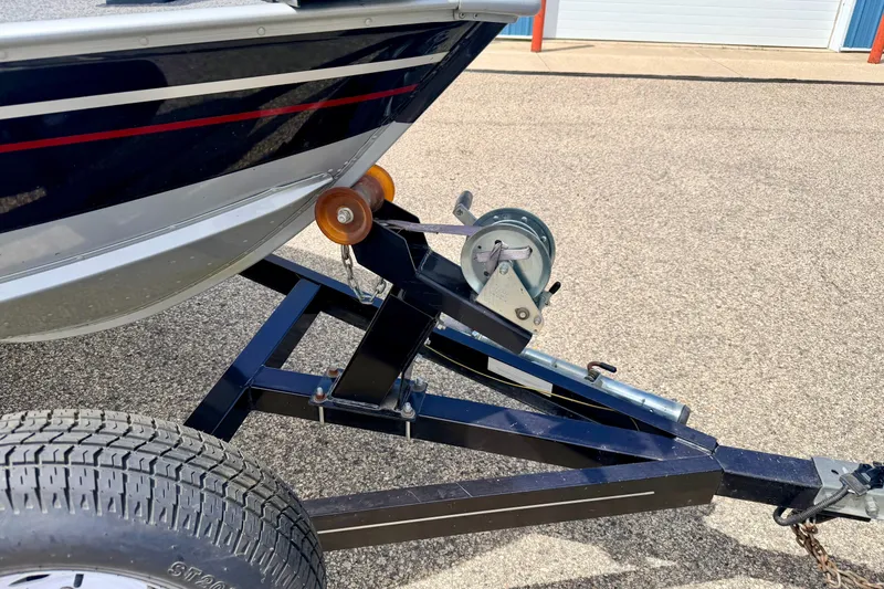 Slide: The Image of Trailer hitch of a 2003 Lund 1675 Adventure SS boat on pavement. - 15