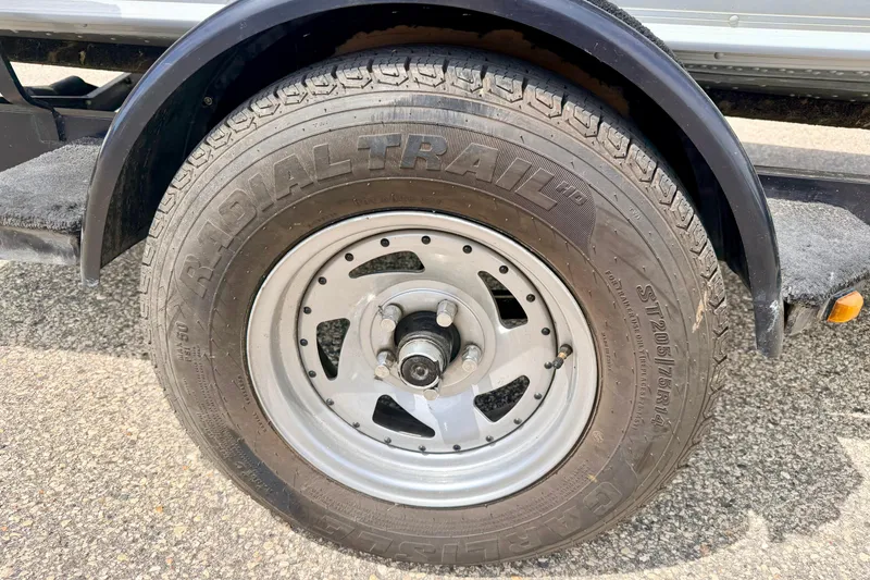 Slide: The Image of Trailer wheel of a 2003 Lund 1675 Adventure SS boat, featuring Radial Trail tire. - 17