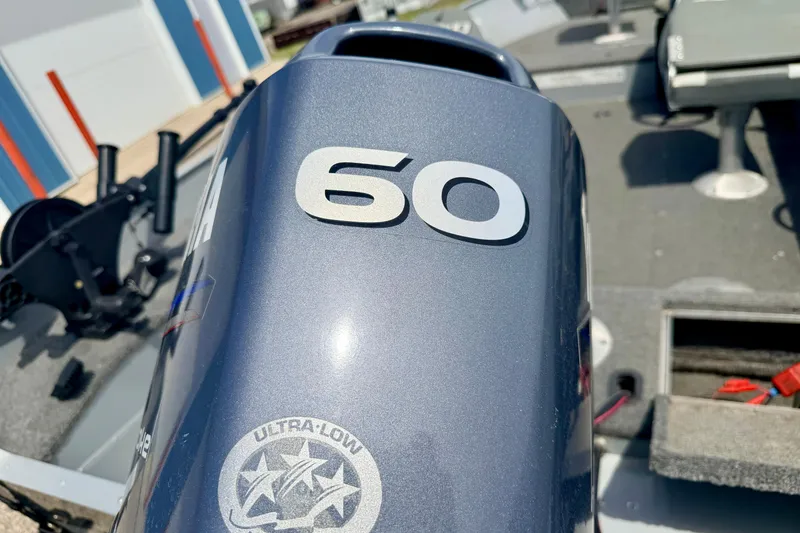 Slide: The Image of Outboard motor on 2003 Lund 1675 Adventure SS boat, featuring "60" horsepower label. - 18