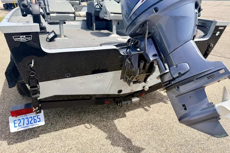 Slide: The Image of 2003 Lund 1675 Adventure SS boat with outboard motor and Michigan trailer plate. - 20