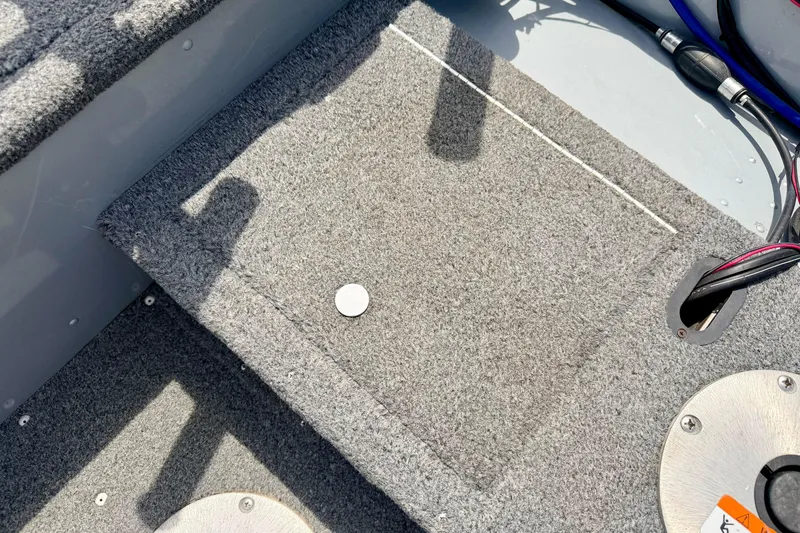 Slide: The Image of Carpeted interior of a 2003 Lund 1675 Adventure SS boat with visible wiring. - 27