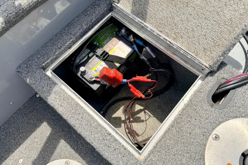Slide: The Image of Battery compartment of a 2003 Lund 1675 Adventure SS boat, showing wiring and connections. - 28