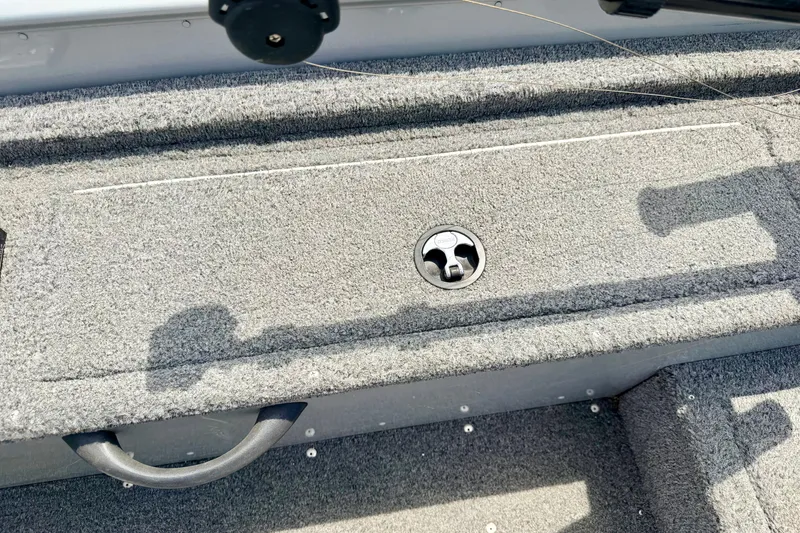 Slide: The Image of Carpeted storage compartment on a 2003 Lund 1675 Adventure SS boat deck. - 30