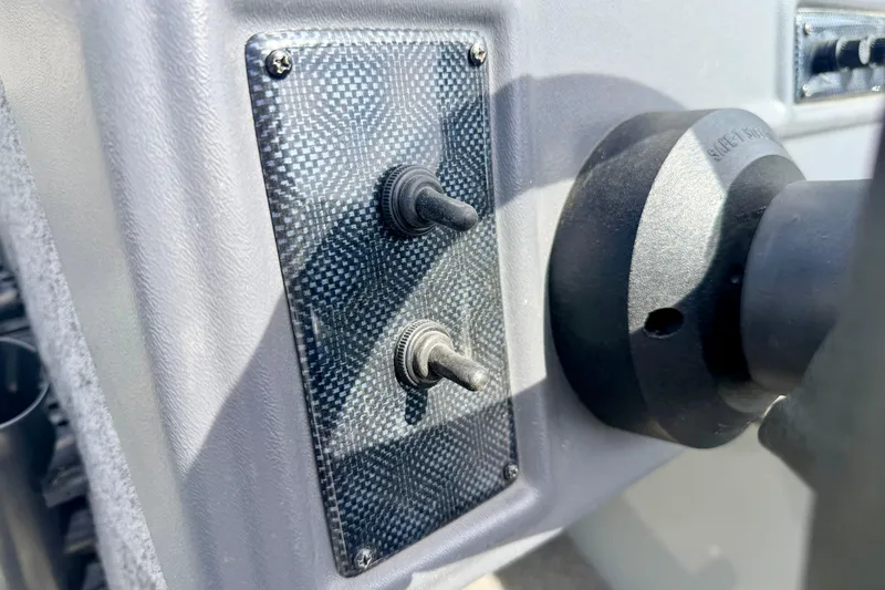 Slide: The Image of Dashboard switches on a 2003 Lund 1675 Adventure SS boat. - 39