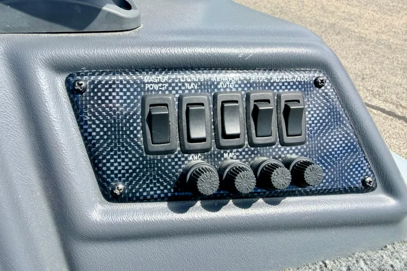 Slide: The Image of Control panel of a 2003 Lund 1675 Adventure SS boat with switches and knobs. - 41