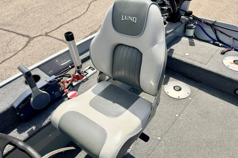 Slide: The Image of 2003 Lund 1675 Adventure SS boat interior with gray seating and control panel. - 48