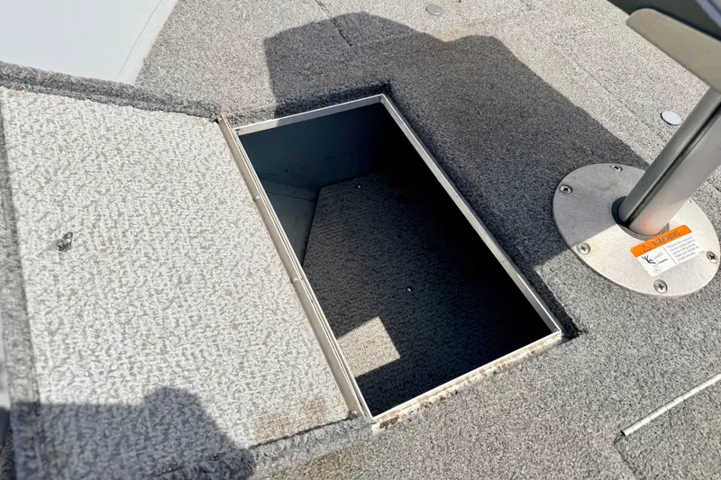 Slide: The Image of Open storage compartment on 2003 Lund 1675 Adventure SS boat deck. - 57