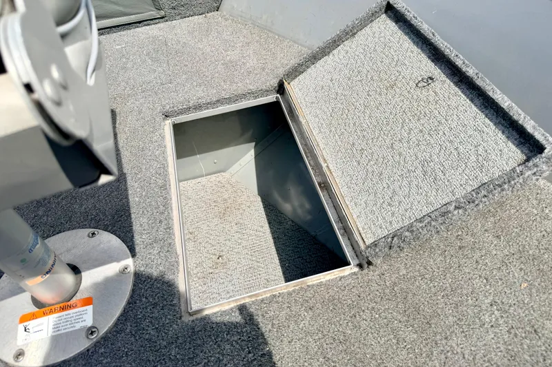 Slide: The Image of Open storage compartment on 2003 Lund 1675 Adventure SS boat deck. - 59