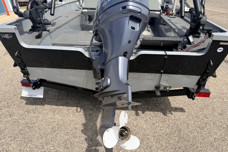 Slide: The Image of Rear view of a 2003 Lund 1675 Adventure SS boat with outboard motor. - 6