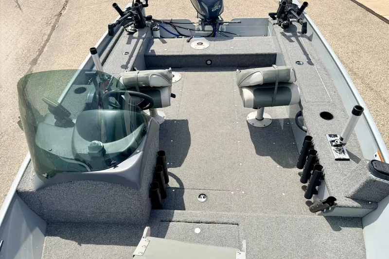 Slide: The Image of 2003 Lund 1675 Adventure SS boat interior with seating and fishing rod holders. - 65
