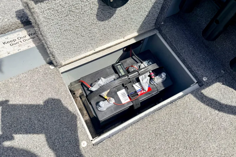 Slide: The Image of Battery compartment in a 2003 Lund 1675 Adventure SS boat, featuring secure installation. - 68