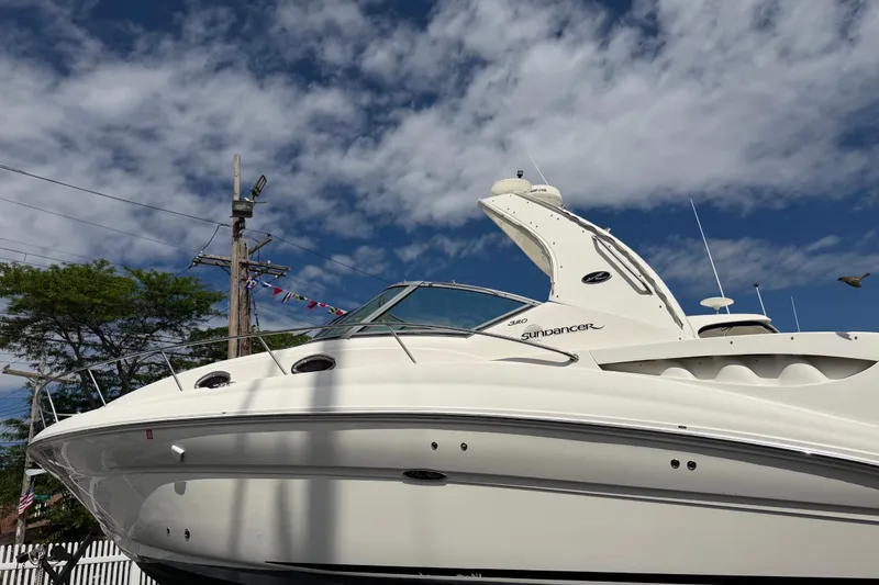 The Image of 2007 Sea Ray Sundancer 320 boat under a partly cloudy sky. - 0