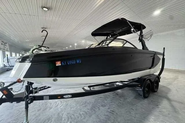 The Image of 2020 Heyday WT-2DC boat in showroom, black and white exterior, on trailer. - 1