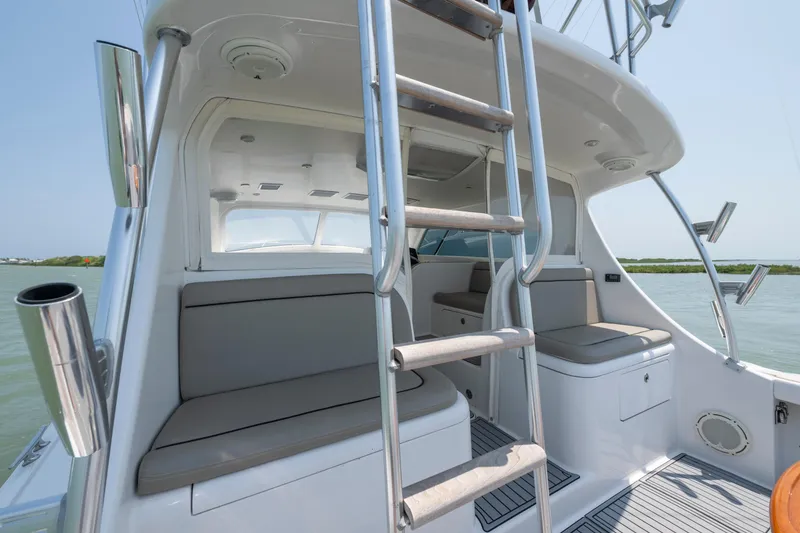 Slide: The Image of 2008 Ocean Yacht 37 Billfish interior with seating and ladder, overlooking serene waters. - 10