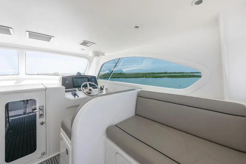 Slide: The Image of Interior of 2008 Ocean Yacht 37 Billfish, featuring helm and seating area with water view. - 14