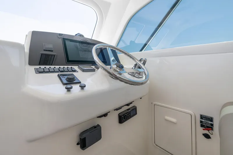 Slide: The Image of Helm of 2008 Ocean Yacht 37 Billfish with steering wheel and control panel. - 17