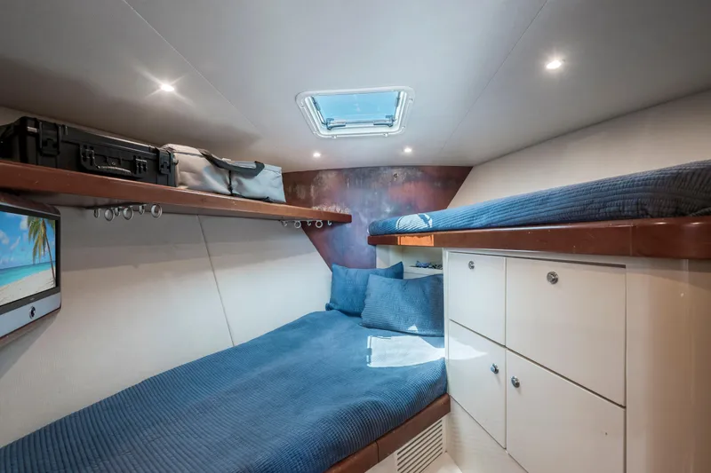 Slide: The Image of Interior cabin of 2008 Ocean Yacht 37 Billfish with cozy bedding and storage. - 21