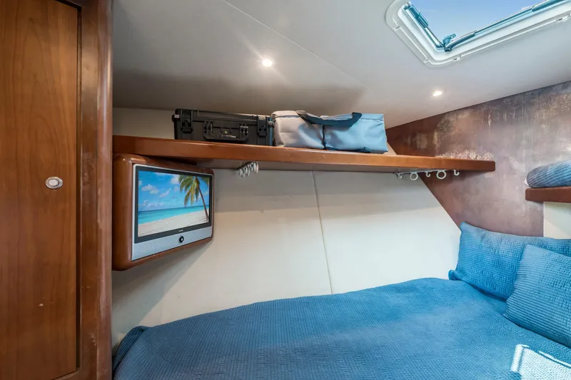 Slide: The Image of Cozy cabin interior of 2008 Ocean Yacht 37 Billfish with TV and storage shelf. - 22