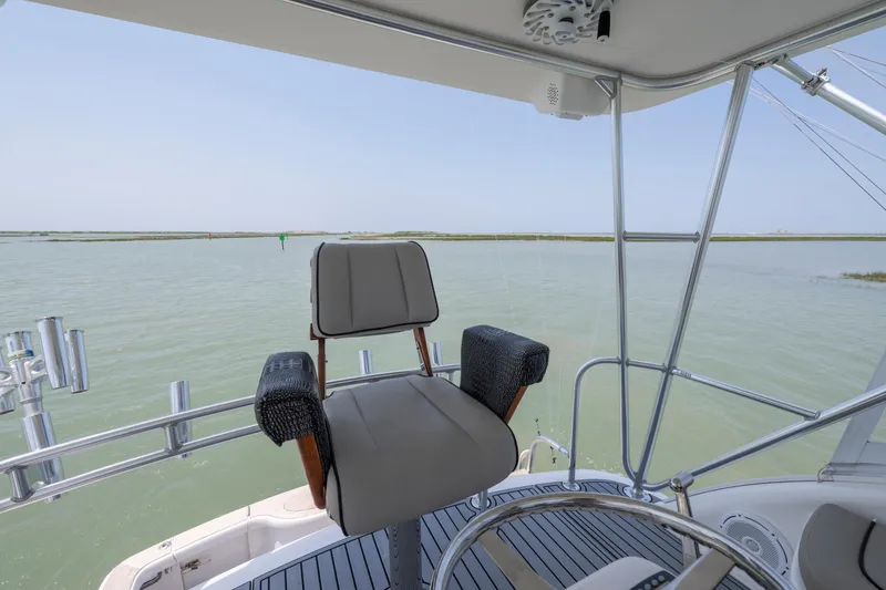 Slide: The Image of Captain's chair on 2008 Ocean Yacht 37 Billfish, overlooking serene waters. - 6