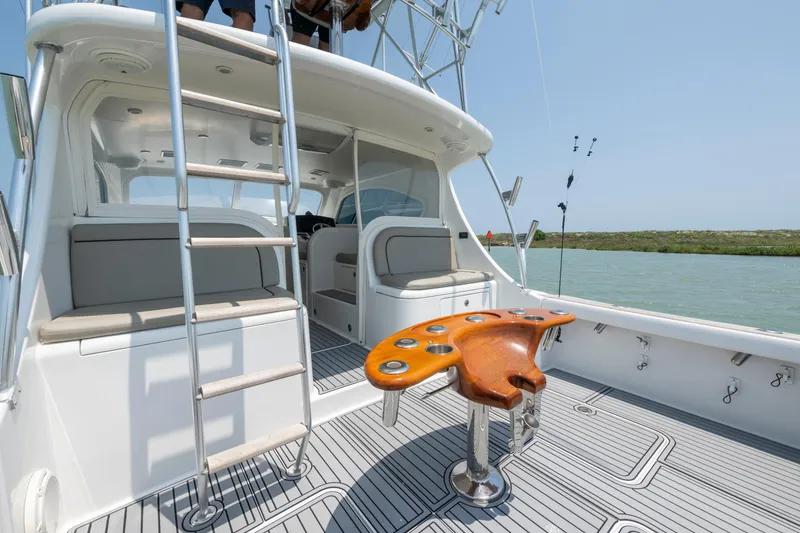 Slide: The Image of 2008 Ocean Yacht 37 Billfish deck with ladder and fishing chair, overlooking serene waters. - 9