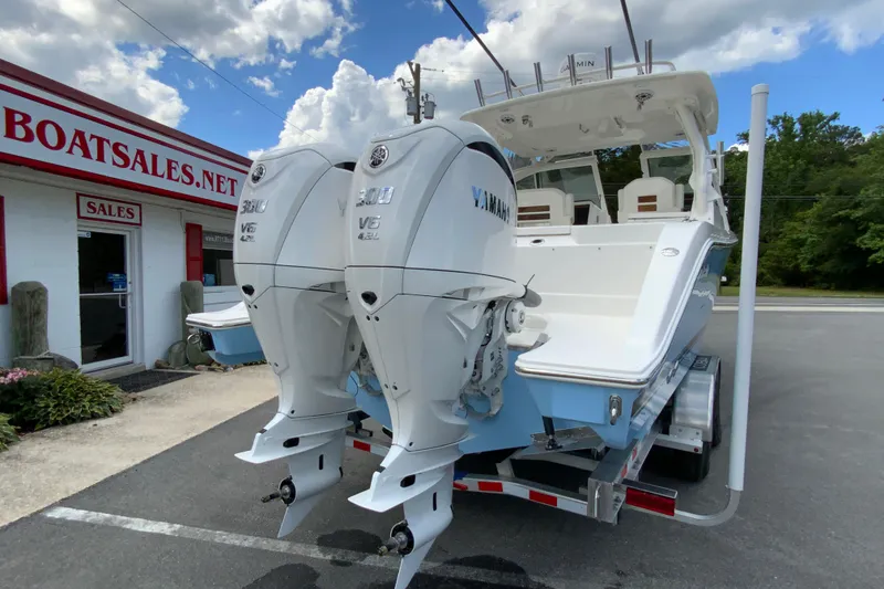 Slide: The Image of 2026 Pursuit DC 286 Dual Console boat with twin Yamaha engines at dealership. - 11