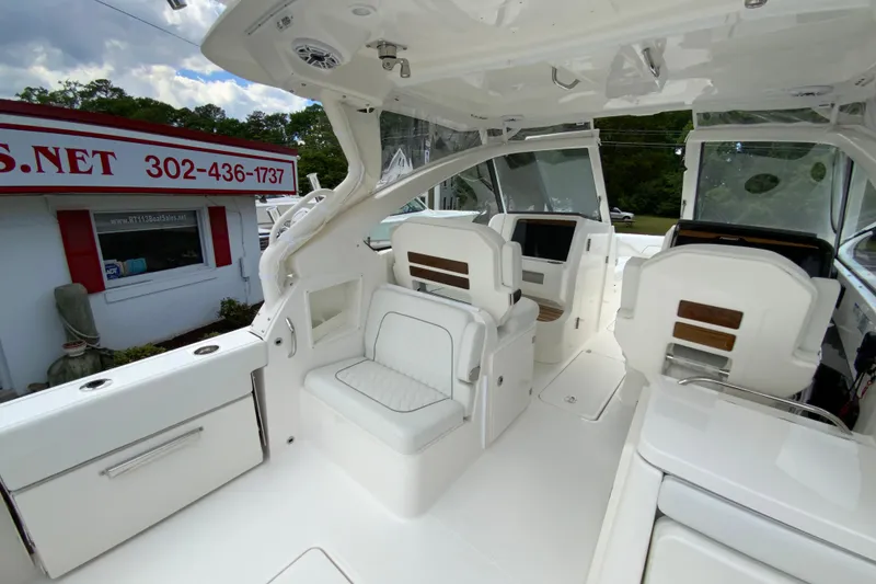 Slide: The Image of Interior of 2026 Pursuit DC 286 Dual Console boat, featuring sleek white seating and modern design. - 14