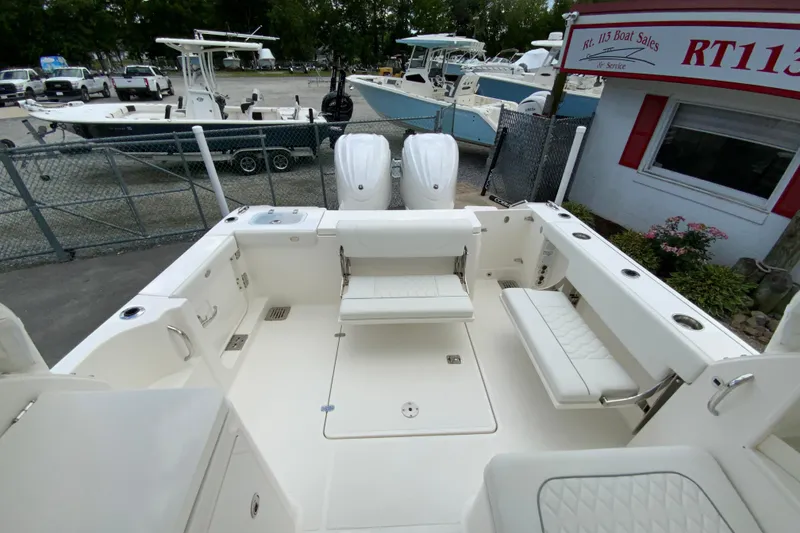 Slide: The Image of 2026 Pursuit DC 286 Dual Console boat interior with seating and storage compartments. - 16