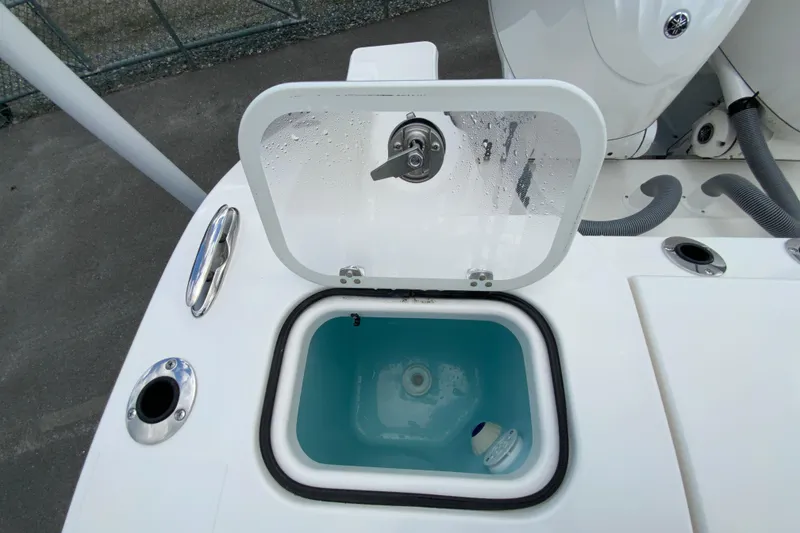 Slide: The Image of Livewell compartment on 2026 Pursuit DC 286 Dual Console boat, featuring a transparent lid. - 18
