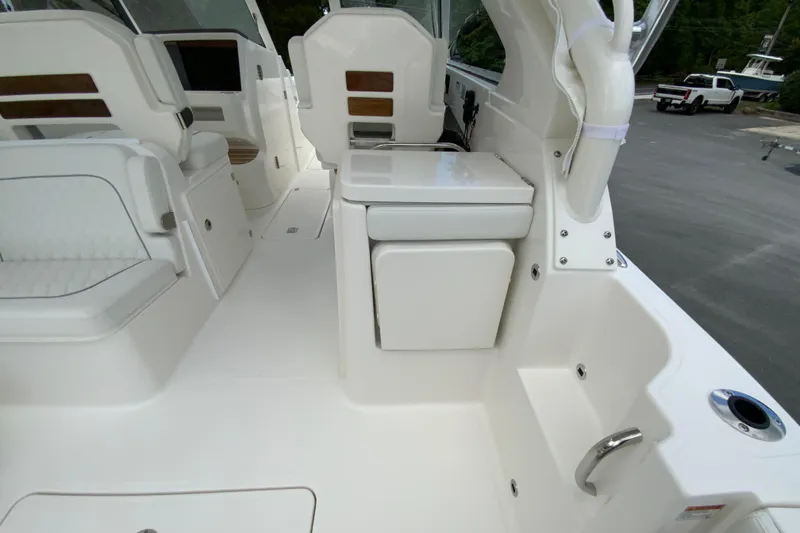 Slide: The Image of 2026 Pursuit DC 286 Dual Console boat interior with white seating and sleek design. - 19