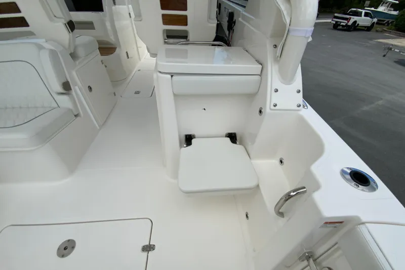 Slide: The Image of 2026 Pursuit DC 286 Dual Console boat interior with seating and storage features. - 20