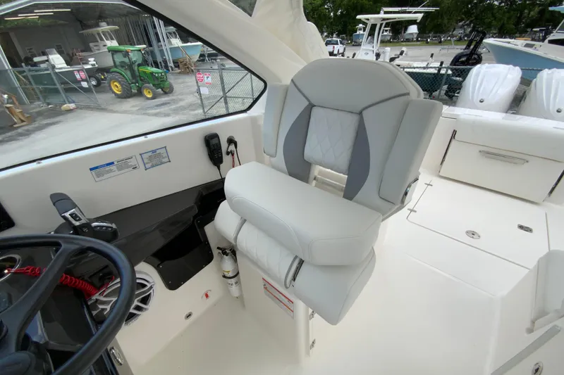 Slide: The Image of 2026 Pursuit DC 286 Dual Console boat interior with modern seating and controls. - 25