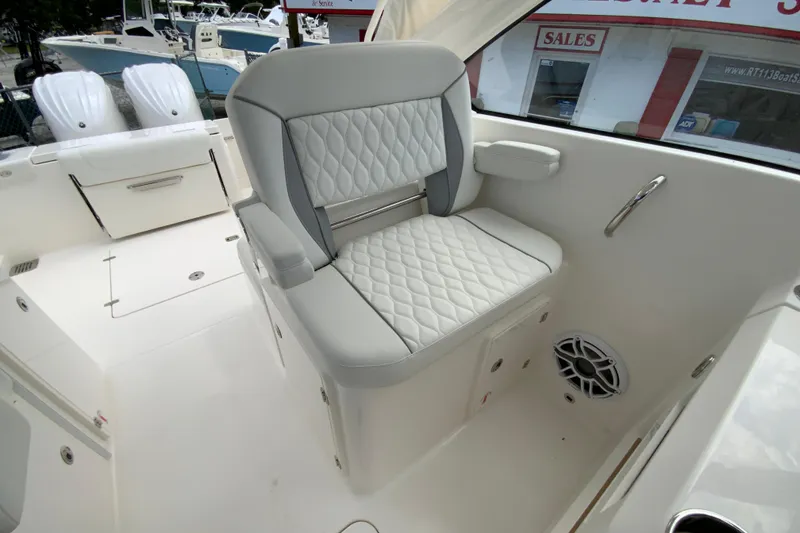 Slide: The Image of Luxurious seating on 2026 Pursuit DC 286 Dual Console boat, featuring quilted upholstery and armrests. - 28