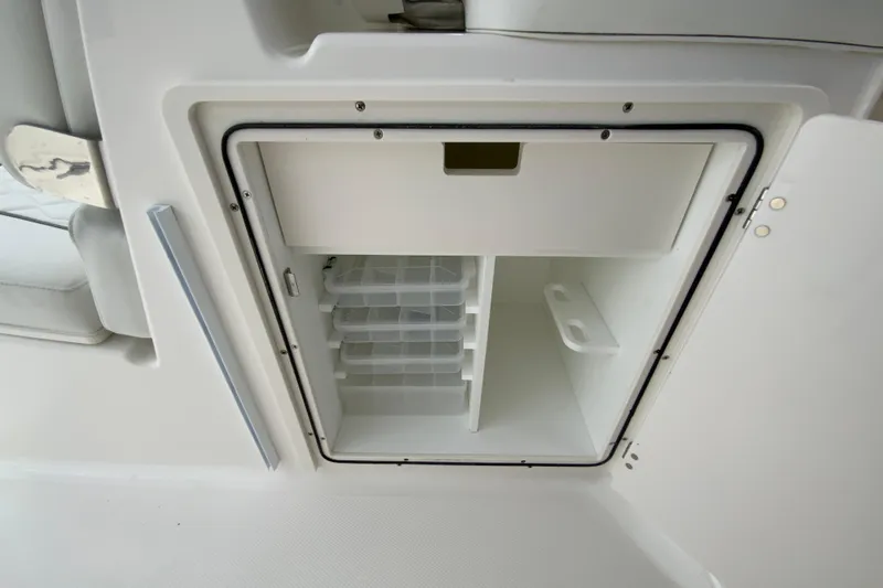 Slide: The Image of Open storage compartment on 2026 Pursuit DC 286 Dual Console boat. - 29