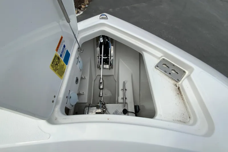 Slide: The Image of Anchor compartment of 2026 Pursuit DC 286 Dual Console boat, showcasing chain and winch system. - 32