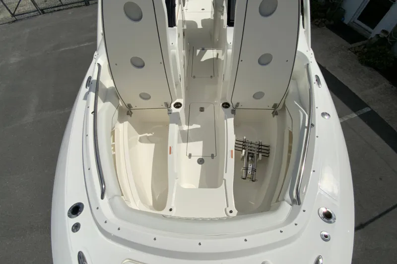 Slide: The Image of 2026 Pursuit DC 286 Dual Console boat interior with open storage compartments. - 33