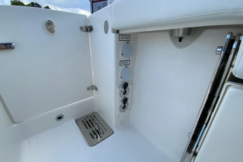 Slide: The Image of Interior view of 2026 Pursuit DC 286 Dual Console boat, featuring water access controls. - 37