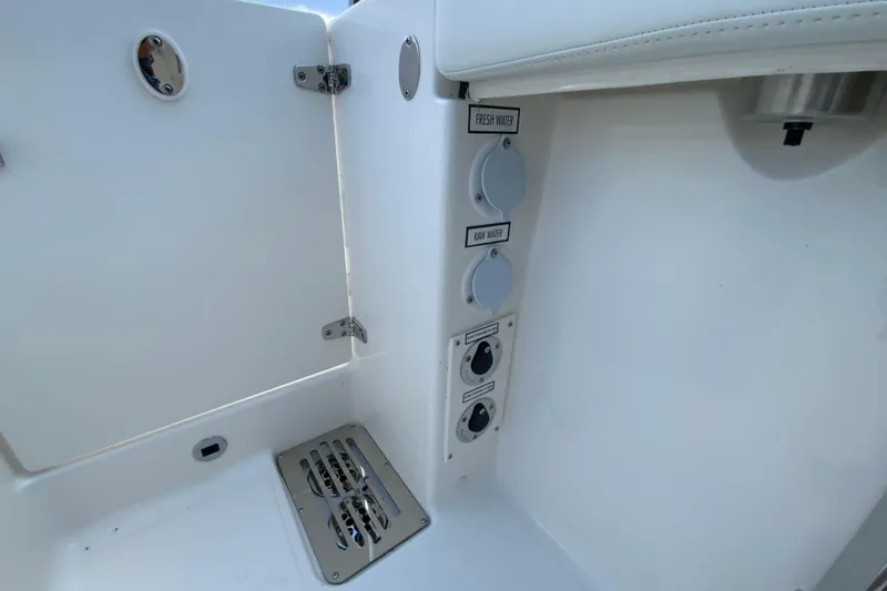 Slide: The Image of Interior view of 2026 Pursuit DC 286 Dual Console boat's water access panel. - 38