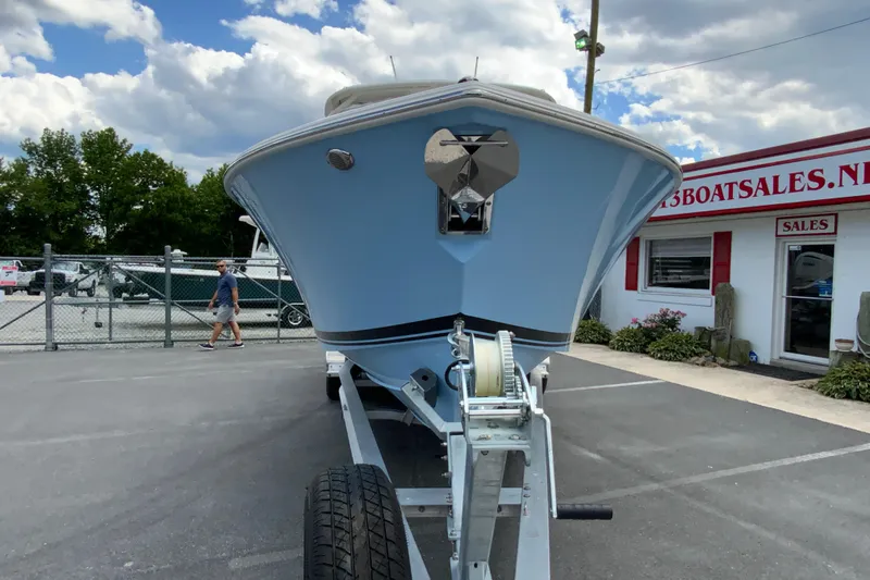 Slide: The Image of 2026 Pursuit DC 286 Dual Console boat on trailer at dealership, under a cloudy sky. - 5
