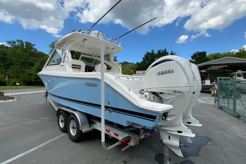 Slide: The Image of 2026 Pursuit DC 286 Dual Console boat with Yamaha engines on a trailer. - 9