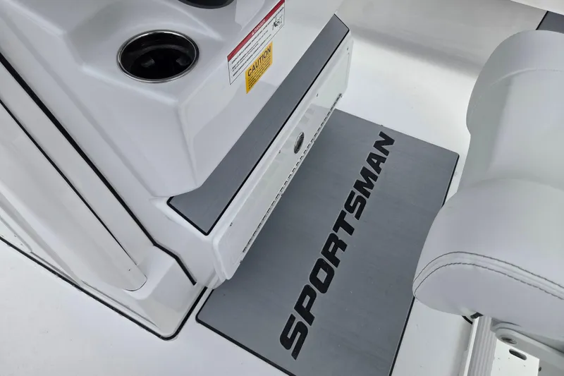 Slide: The Image of 2026 Sportsman Masters 247 Bay Boat interior with branded mat and cup holders. - 10